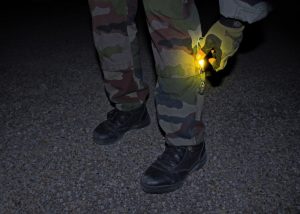 Identify soldiers with a yellow Cyalume stick attached to the calf area