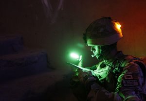 Military Identification with mini cyalume sticks on soldier's helmets