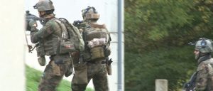 a group of soldiers with identification patches on their helmets